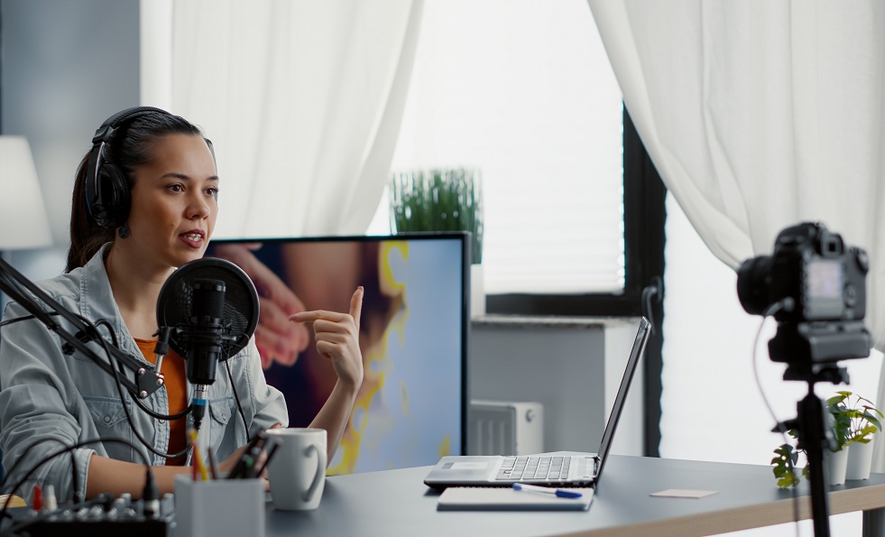 digital-content-creator-recording-video-living-room-studio-while-tweaking-knobs-mixer-internet-live-broadcast-talk-show-host-talking-microphone-with-audience-while-using-audio-equipment